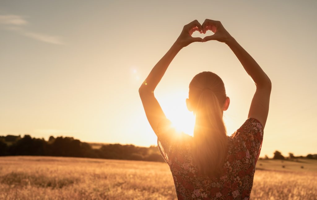 Young,Won,Standing,In,A,Field,Facing,A,Beautiful,Sunrise