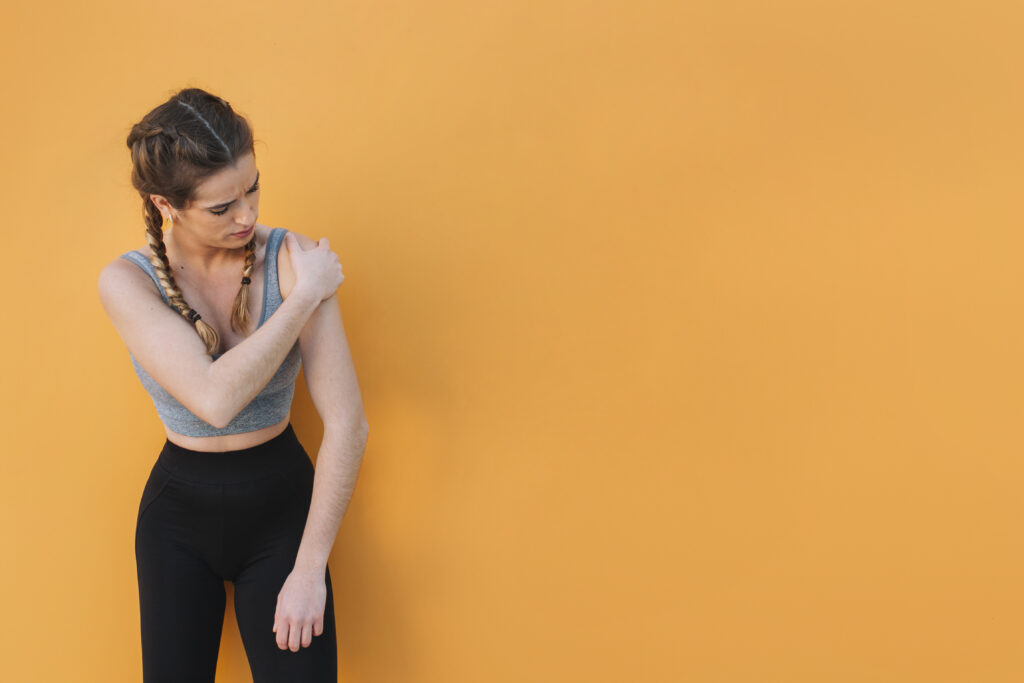 woman-touching-injured-shoulder