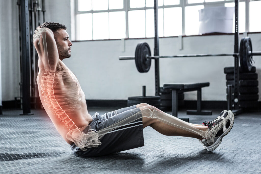 Digital,Composite,Of,Highlighted,Spine,Of,Exercising,Man,At,Gym